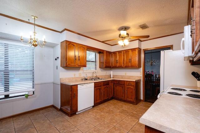 kitchen with ceiling fan with notable chandelier, hanging light fixtures, a textured ceiling, sink, and white appliances