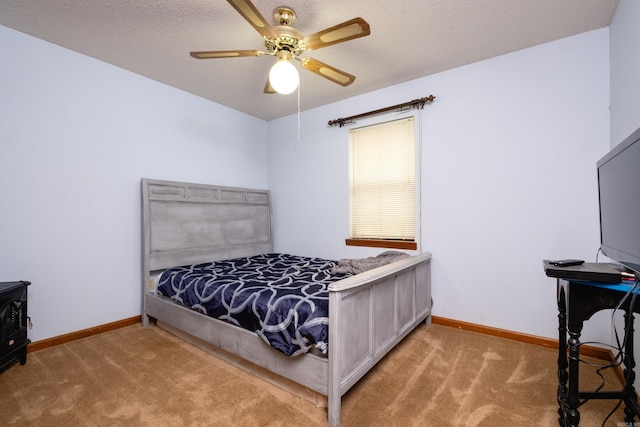 bedroom featuring ceiling fan, a textured ceiling, and light colored carpet