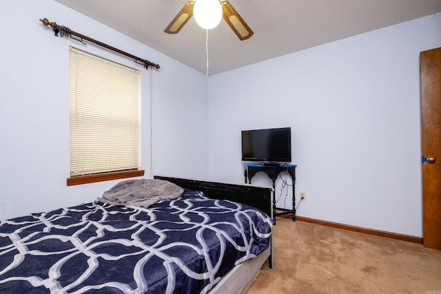 carpeted bedroom featuring a textured ceiling and ceiling fan