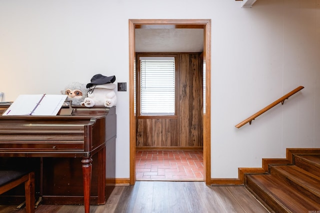 miscellaneous room featuring wood walls and wood-type flooring