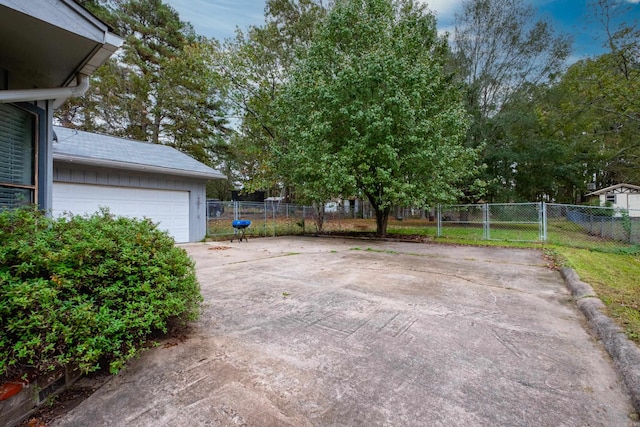 view of patio featuring an outbuilding and a garage