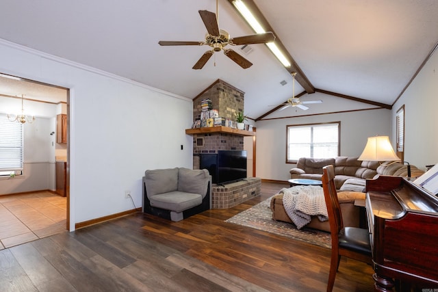 living room with a fireplace, hardwood / wood-style flooring, ceiling fan with notable chandelier, and vaulted ceiling with beams