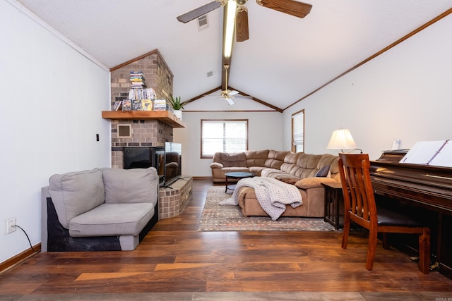 living room with a brick fireplace, ornamental molding, dark wood-type flooring, and vaulted ceiling with beams