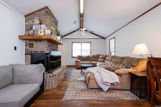 living room featuring dark hardwood / wood-style flooring, lofted ceiling with beams, ceiling fan, and a fireplace