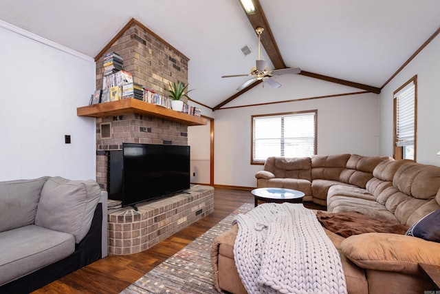 living room featuring a brick fireplace, dark hardwood / wood-style flooring, vaulted ceiling with beams, ornamental molding, and ceiling fan