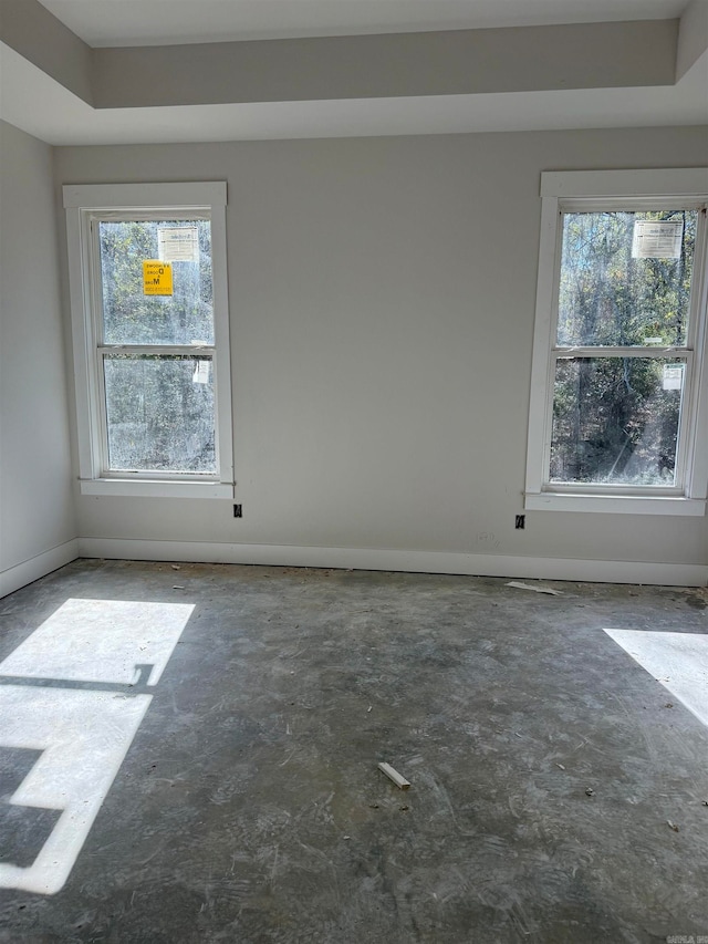 empty room featuring a raised ceiling