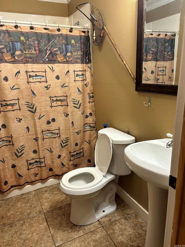 bathroom with ornamental molding, toilet, walk in shower, and tile patterned floors