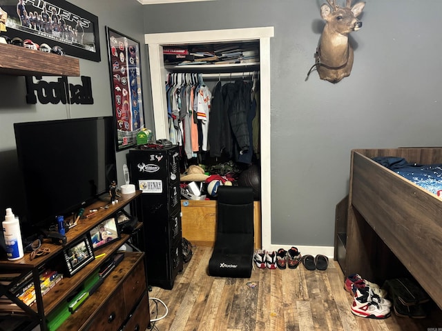 bedroom with a closet and light hardwood / wood-style flooring