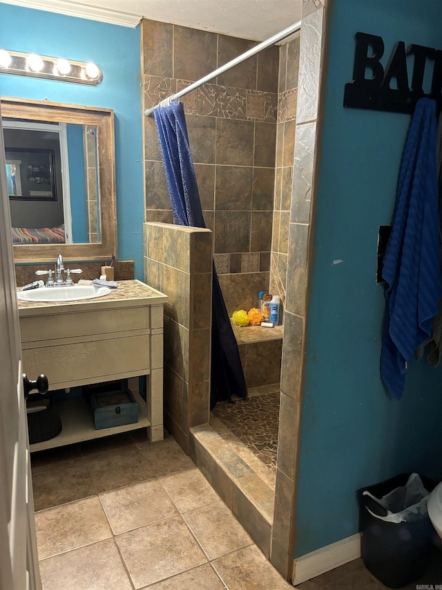 bathroom with a shower with curtain, vanity, tile patterned floors, and a textured ceiling