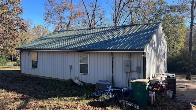 view of side of home featuring cooling unit