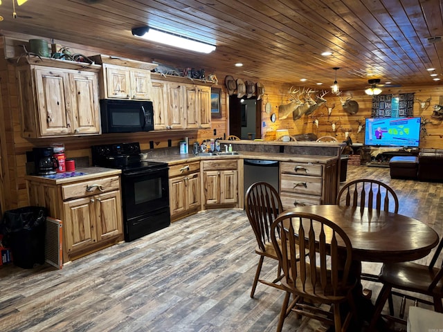 kitchen featuring wood-type flooring, black appliances, wooden walls, wooden ceiling, and ceiling fan