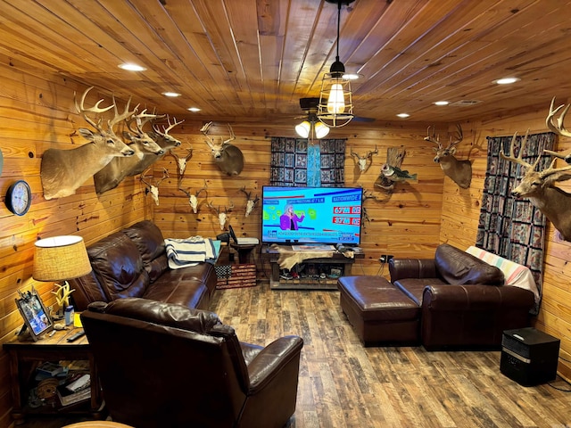 living room with hardwood / wood-style floors, wooden ceiling, and wooden walls