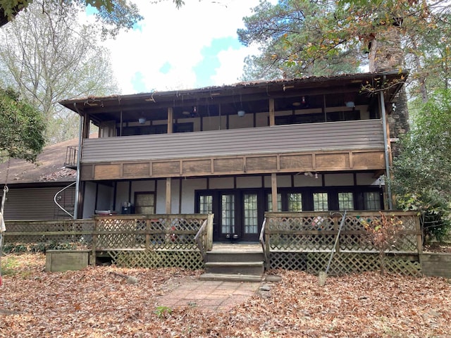 view of front of house with french doors and a wooden deck