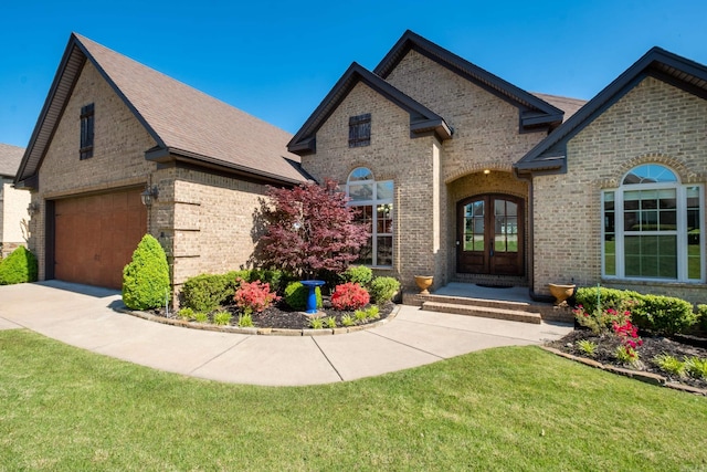 french country inspired facade featuring french doors, a garage, and a front lawn