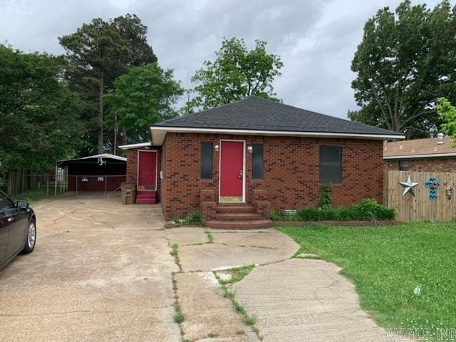 view of front facade with a carport and a front lawn