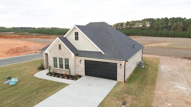 view of front of property with a front yard and central AC