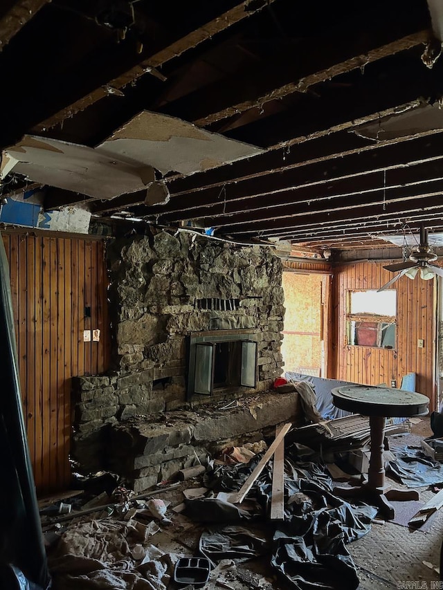 miscellaneous room featuring wooden walls and ceiling fan