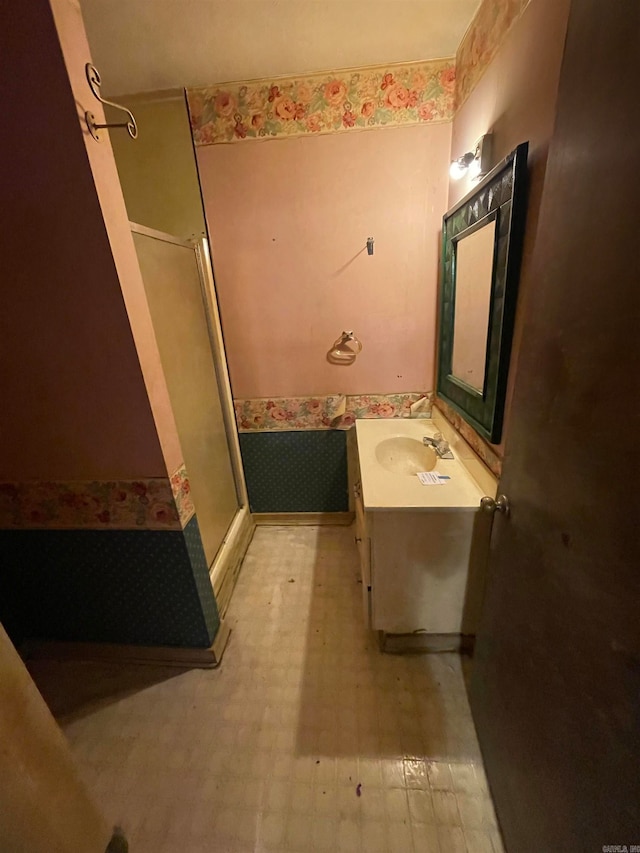 bathroom with walk in shower and vanity