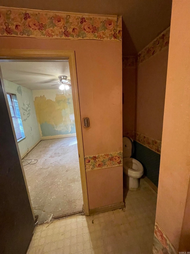 bathroom featuring ceiling fan and toilet