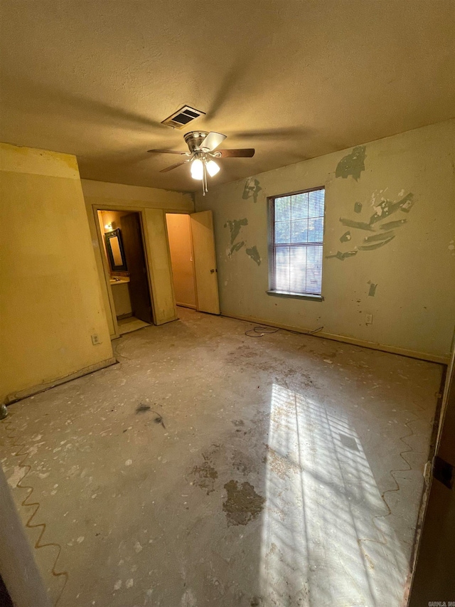 unfurnished bedroom with a textured ceiling and ceiling fan