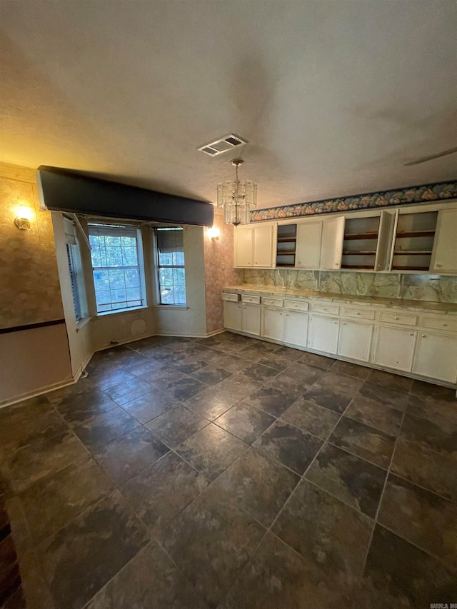 kitchen with white cabinets and decorative light fixtures