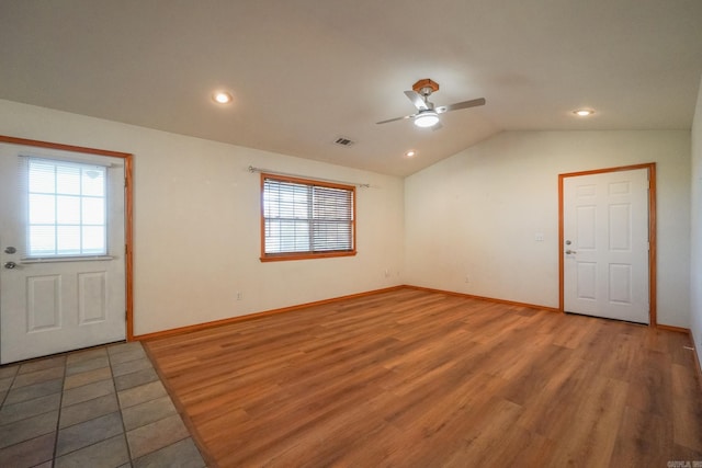 foyer featuring hardwood / wood-style flooring, ceiling fan, and vaulted ceiling