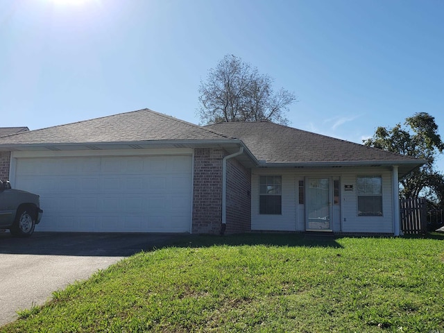 single story home with a garage and a front yard