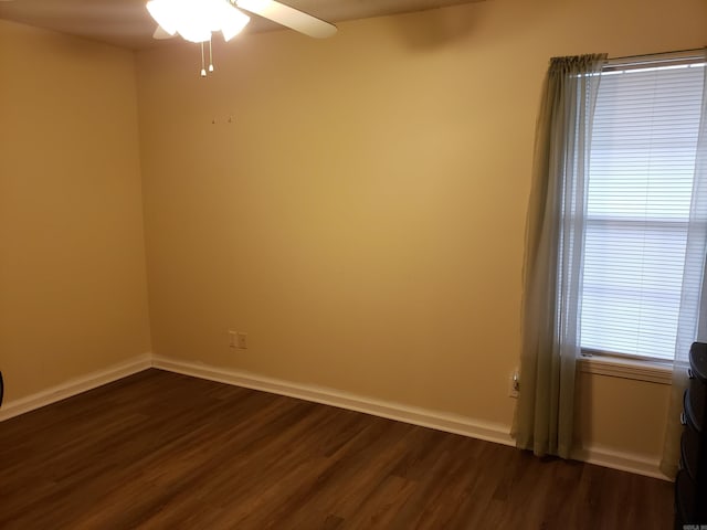 empty room featuring dark hardwood / wood-style flooring and ceiling fan