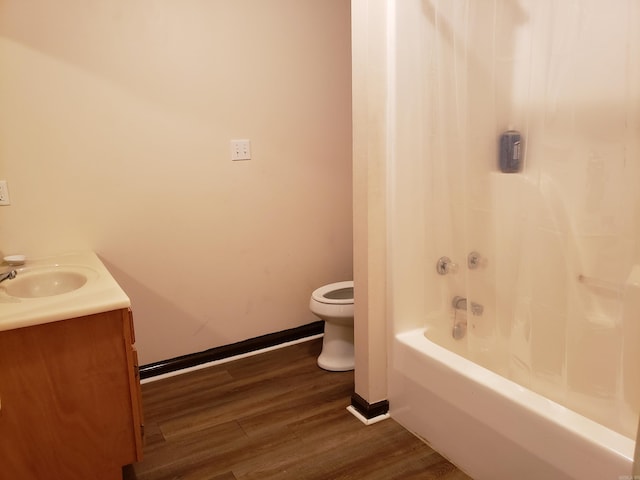 full bathroom with hardwood / wood-style floors, vanity, toilet, and shower / bath combination