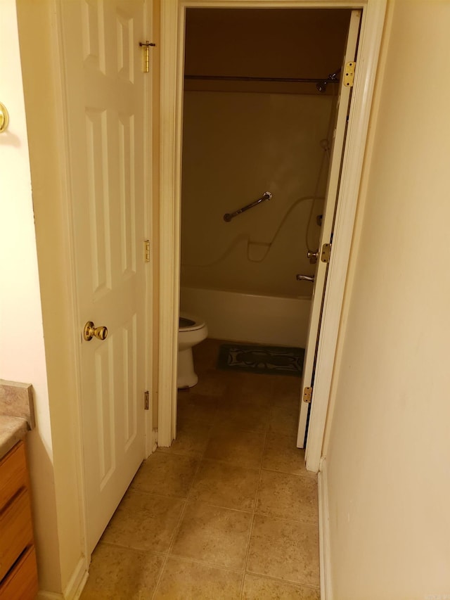 bathroom featuring a shower, tile patterned flooring, vanity, and toilet