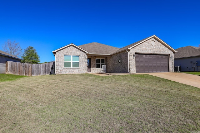 ranch-style home featuring a garage and a front lawn