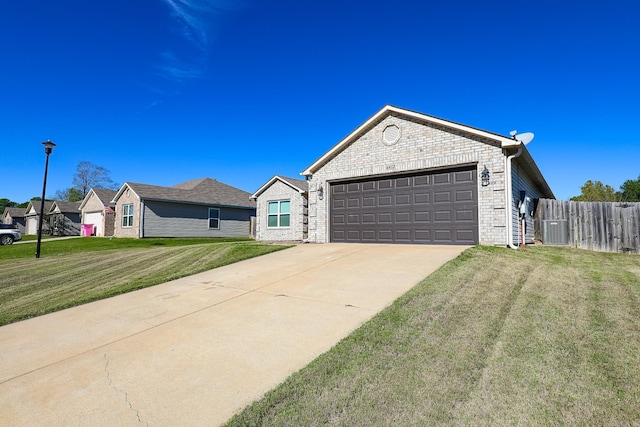 ranch-style house with central AC unit, a front yard, and a garage