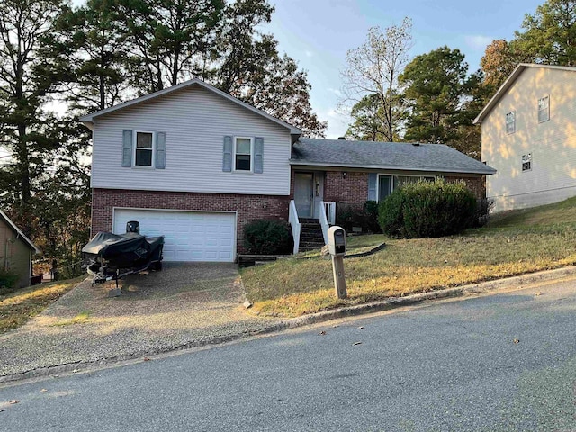 split level home featuring a garage and a front yard