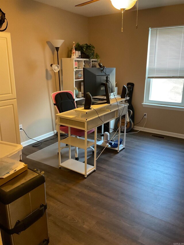 home office with ceiling fan and dark wood-type flooring