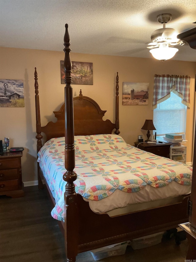 bedroom featuring a textured ceiling, dark hardwood / wood-style flooring, and ceiling fan