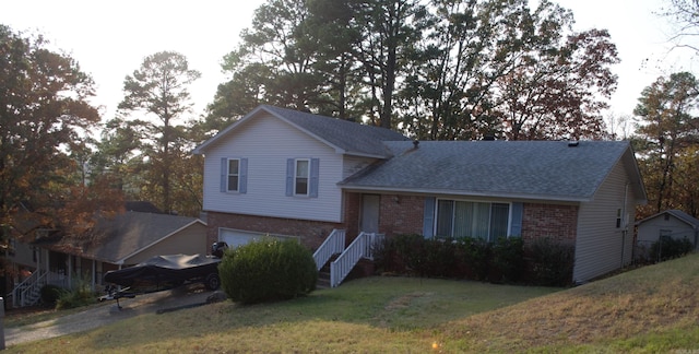 split level home with a garage and a front lawn