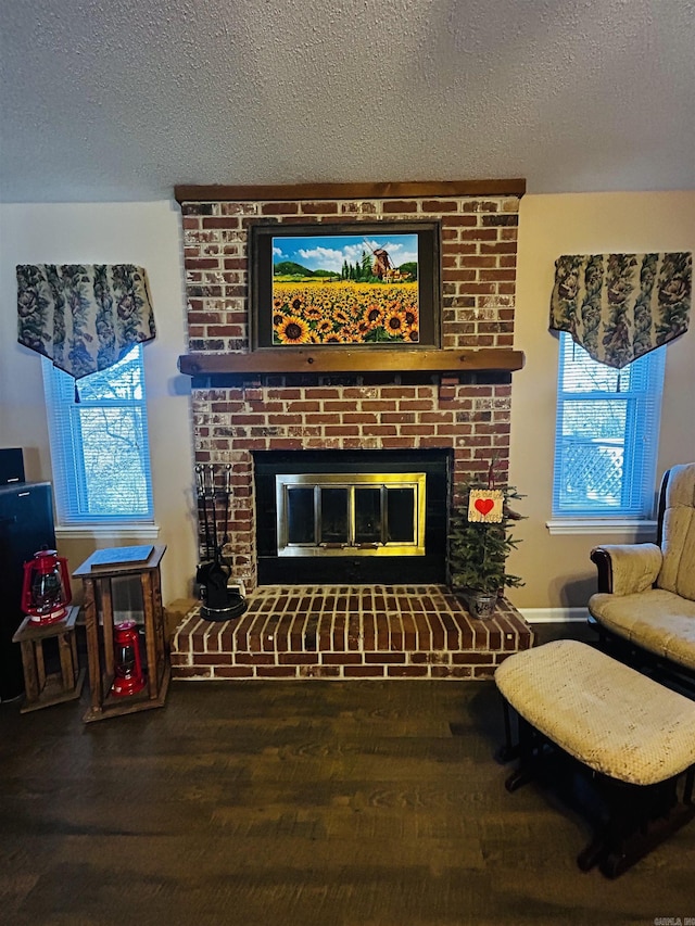 living room with a fireplace, wood-type flooring, and a textured ceiling