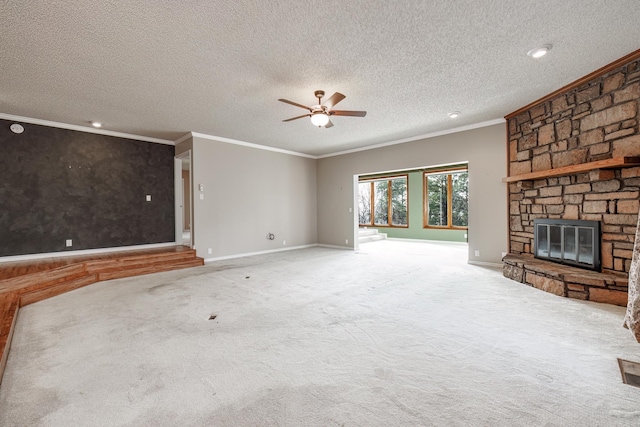 unfurnished living room featuring carpet flooring, ornamental molding, a textured ceiling, ceiling fan, and a fireplace