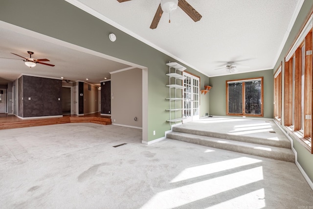 spare room featuring crown molding, carpet floors, and a textured ceiling