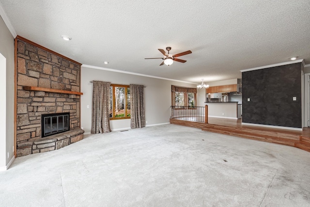 unfurnished living room featuring a stone fireplace, ceiling fan with notable chandelier, a textured ceiling, and ornamental molding