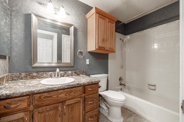 full bathroom featuring tile patterned floors, vanity, a textured ceiling, toilet, and tiled shower / bath