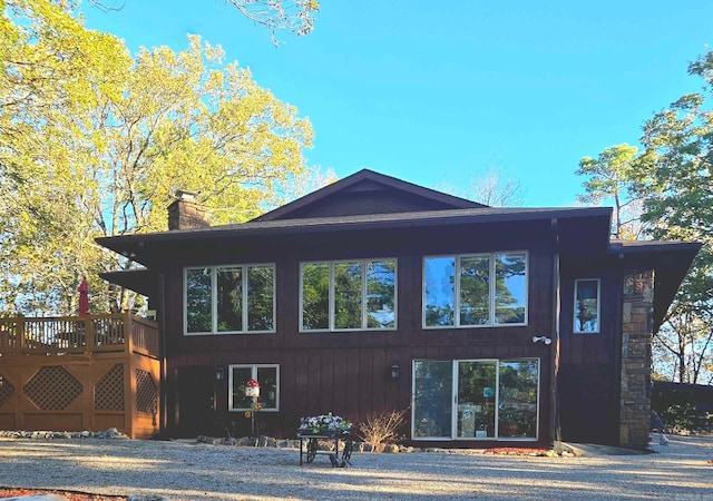 back of property with a wooden deck