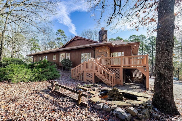 rear view of property featuring a deck