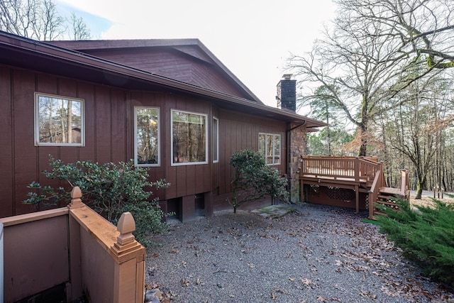 view of property exterior with a wooden deck