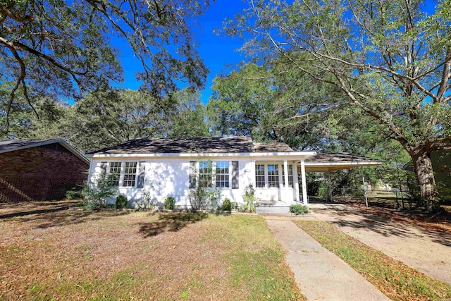 ranch-style home with a front lawn and a carport