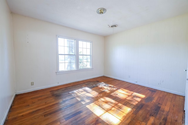 spare room featuring dark hardwood / wood-style flooring