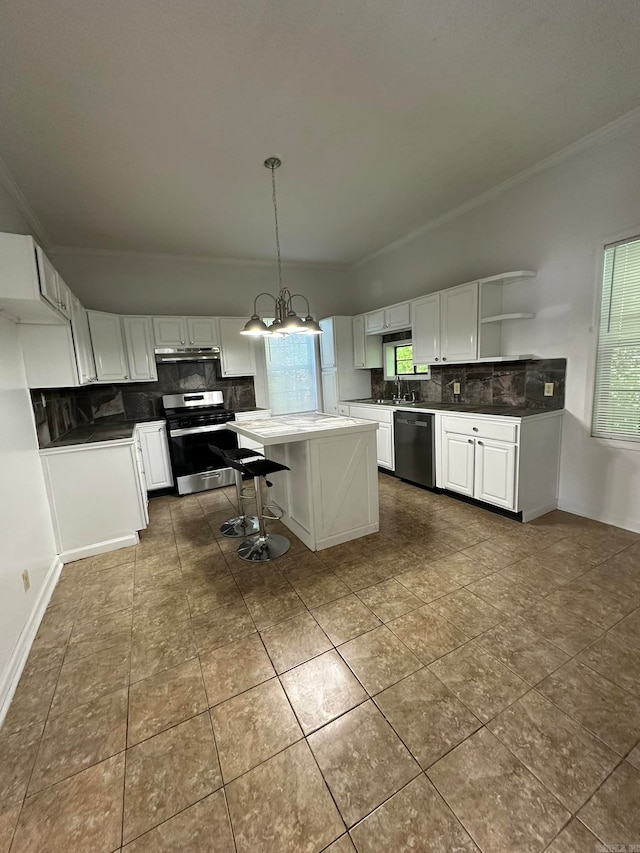 kitchen featuring pendant lighting, white cabinetry, stainless steel range oven, and a kitchen island