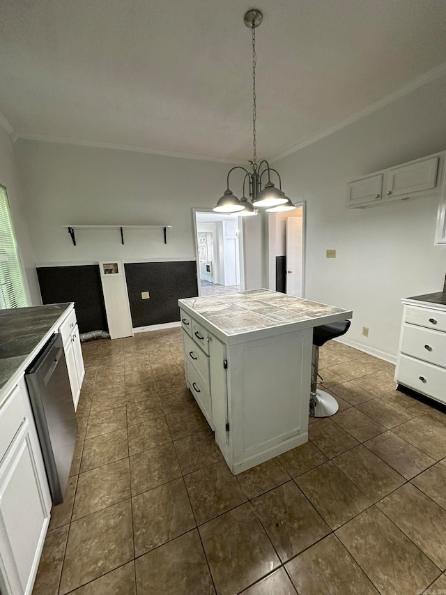 kitchen with a kitchen island, a notable chandelier, white cabinets, pendant lighting, and dishwasher