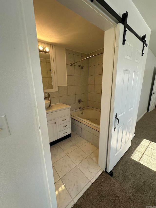 bathroom featuring vanity, tile patterned floors, and tiled shower / bath combo