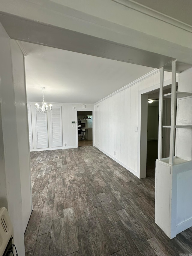 unfurnished living room featuring dark hardwood / wood-style floors and a notable chandelier